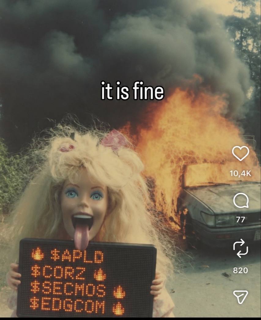 A Barbie doll with its tongue out holds an LED sign reading $APLD $CORZ $SECMOS $EDGCOM with flame icons, in front of a burning car. Caption: it is fine.